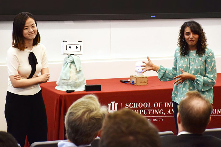 Students Tingyu Li and Pavithra Ramamurthy stand with a robot for the Cheng Wu Innovation Challenge.