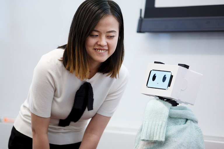 Student Tingyu Li stands with her robot for the Cheng Wu Innovation Challenge.