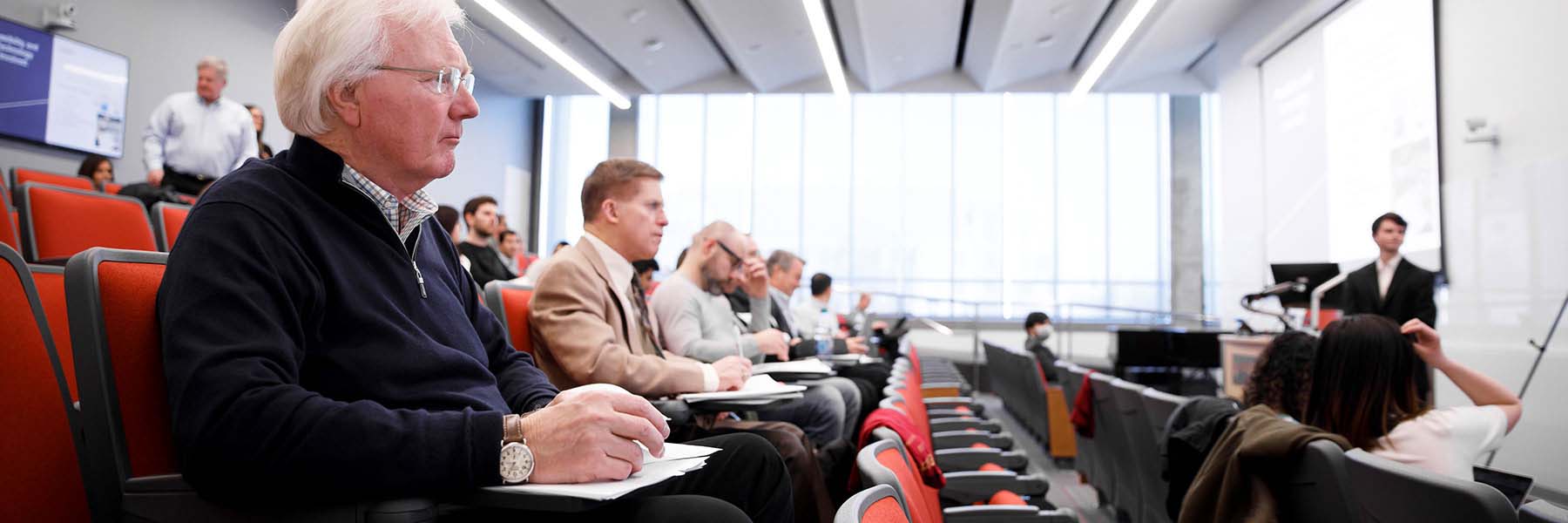 A student gives a presentation in a large lecture room for the Cheng Wu Innovation Challenge.