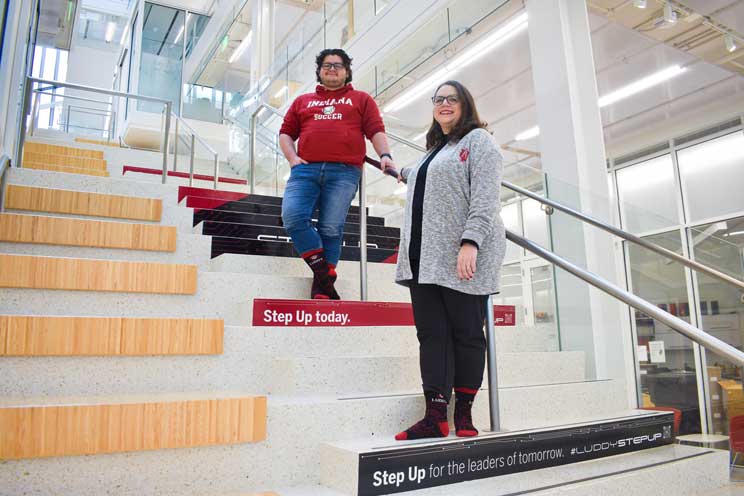 Terrance and his mother posing on the stairs inside of Luddy Hall