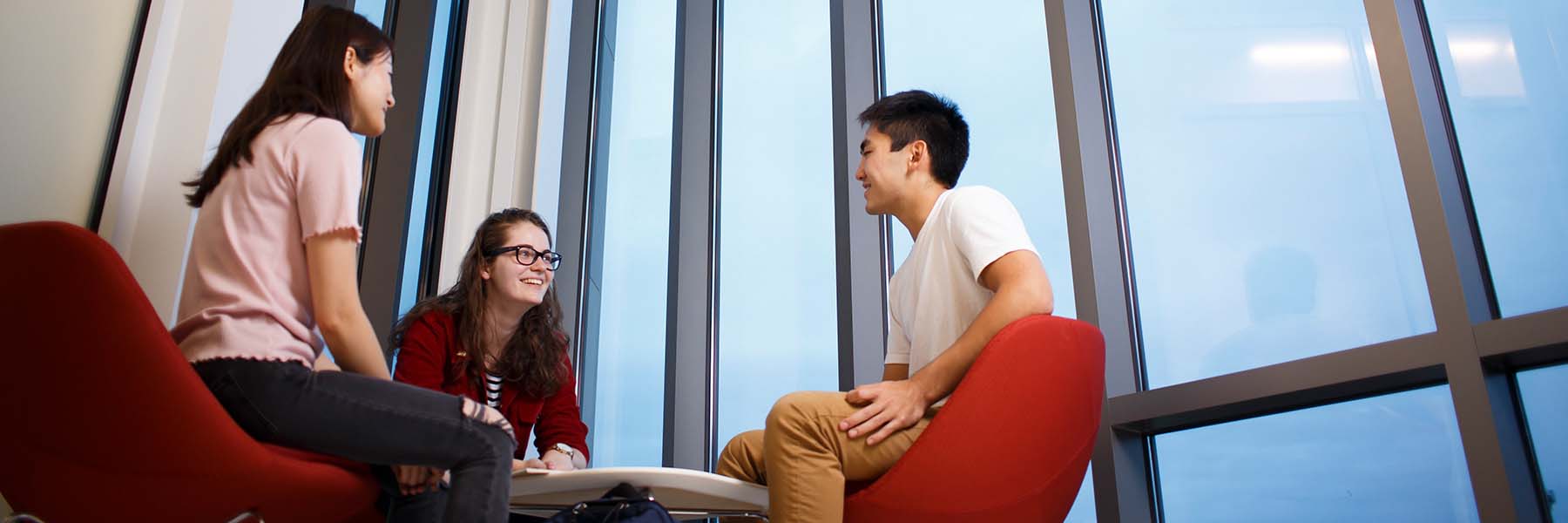 A group of students sit and talk in a common space in Luddy Hall.